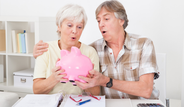 Senior Couple Holding a Piggy Bank